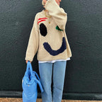 Clara | Pull Oversize Design Smiley Éclatant